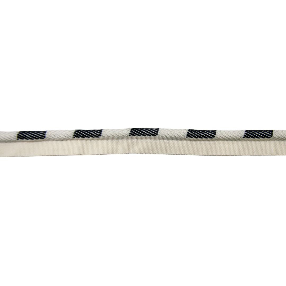 Close-up of a cream cord with black checkered pattern on a white background