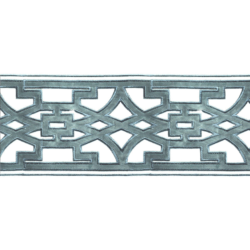 A photo showing a close-up of a velvet embossed decorative trim tape with a geometric pattern in Williamsburg blue color.