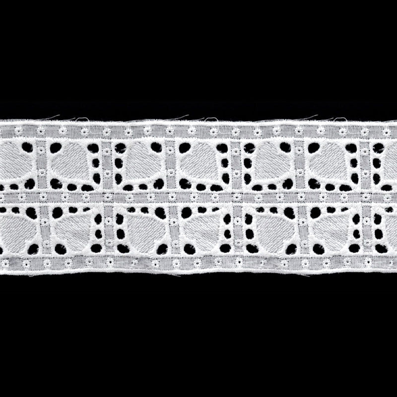 A roll of white flat eyelet lace trim with a floral and heart pattern.