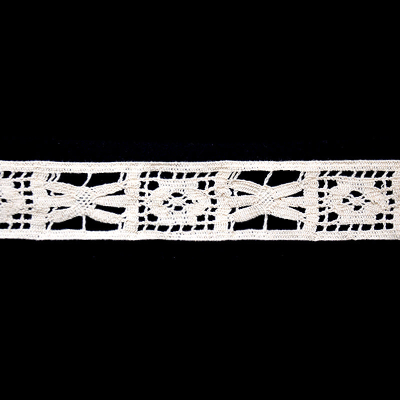 A 25-yard roll of ivory Cotton Cluny Lace with a floral openwork pattern, 1 1/2 inch in width.