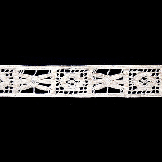 A 25-yard roll of ivory Cotton Cluny Lace with a floral openwork pattern, 1 1/2 inch in width.