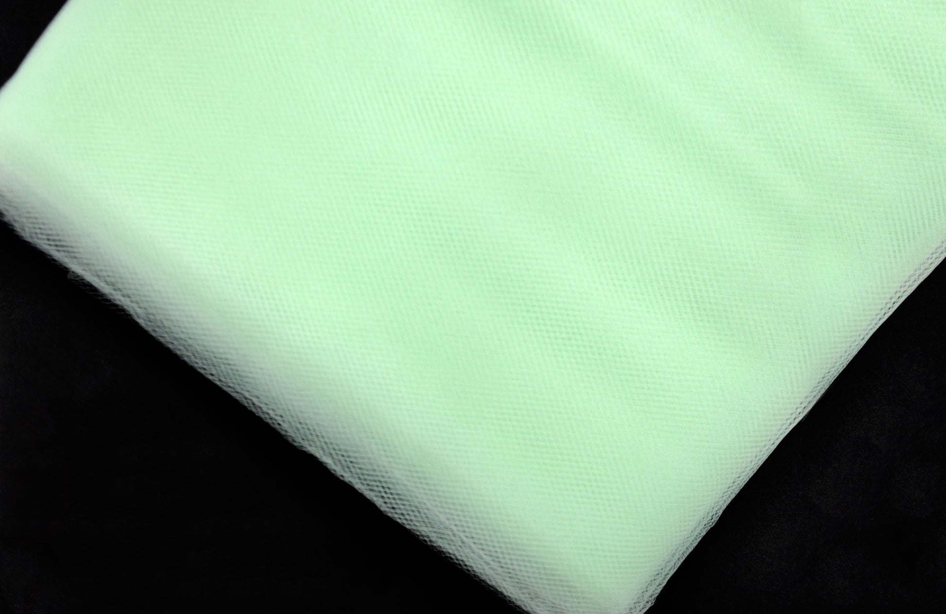 A bolt of mint green tulle fabric.
