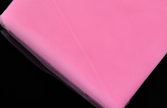 A bolt of pink tulle fabric.
