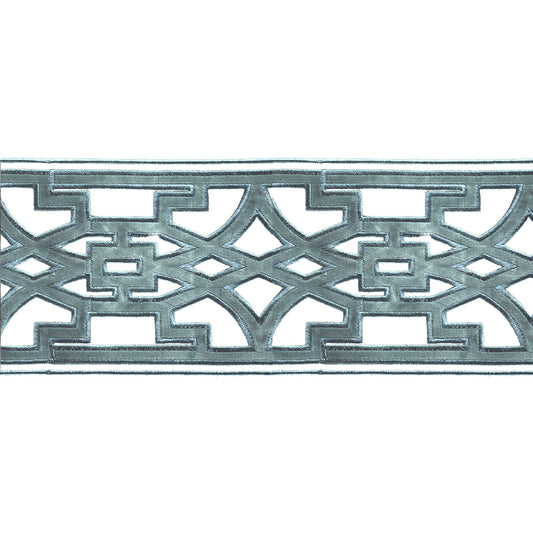 A photo showing a close-up of a velvet embossed decorative trim tape with a geometric pattern in Williamsburg blue color.