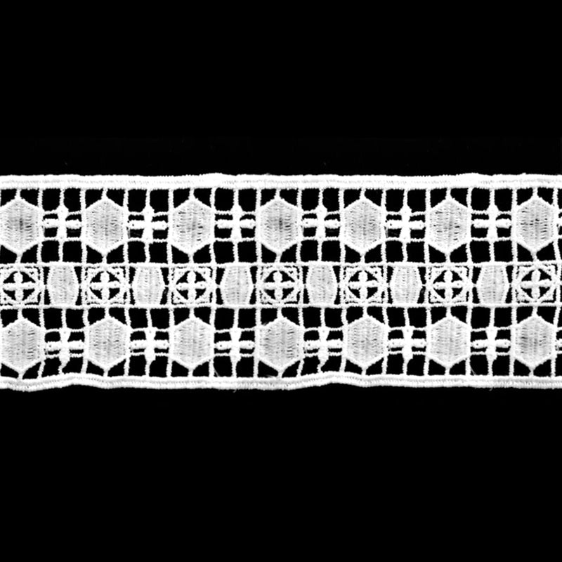 A close-up of a white Venice lace trim with a geometric pattern.