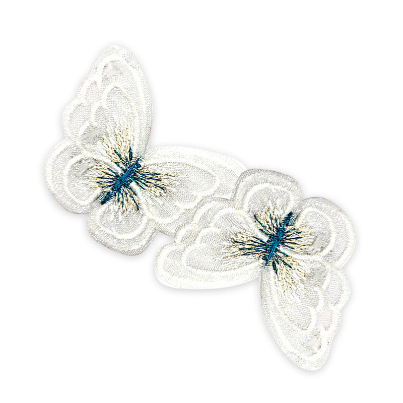 A pair of white embroidered butterfly appliques with blue details on a transparent background.