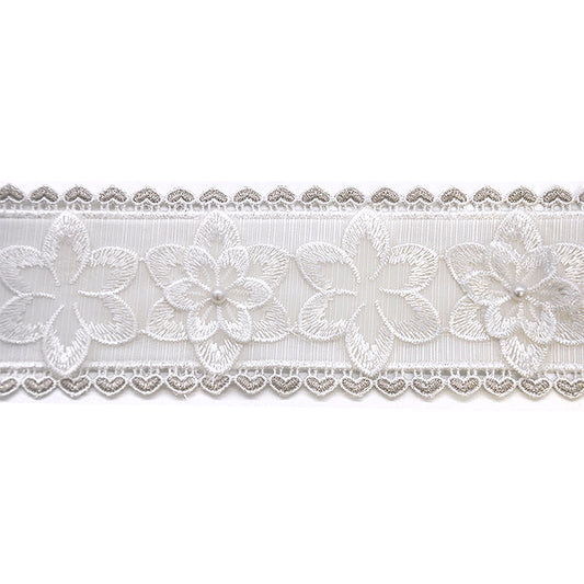 A roll of floral lace trimming with a white on white color scheme, featuring layered floral patterns and pearls.